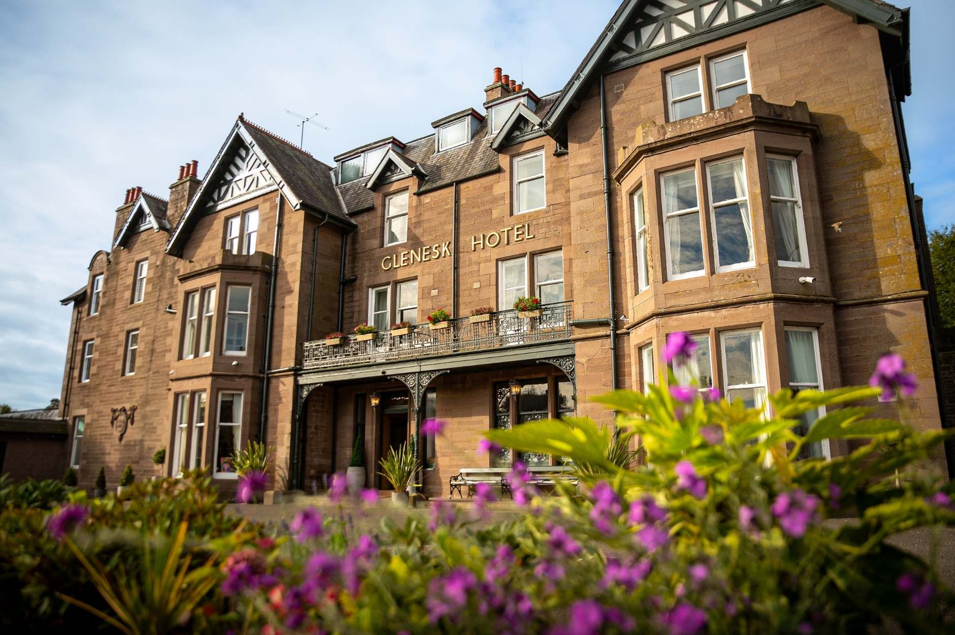 Front view of the Glenesk Hotel exterior with flowers in the foreground