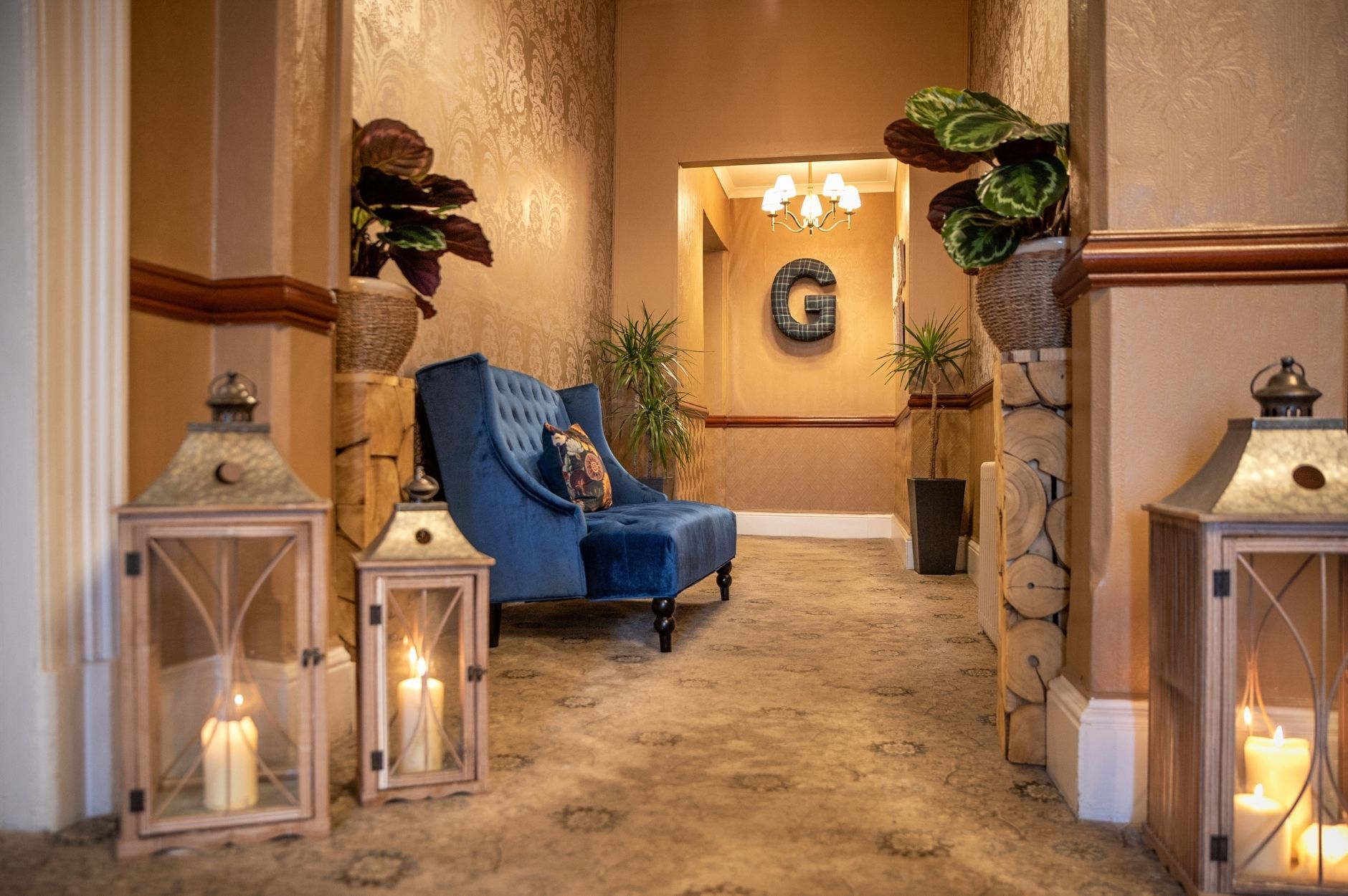 Glenesk Hallway View with luxury Sofa, lit candles in candle lanterns