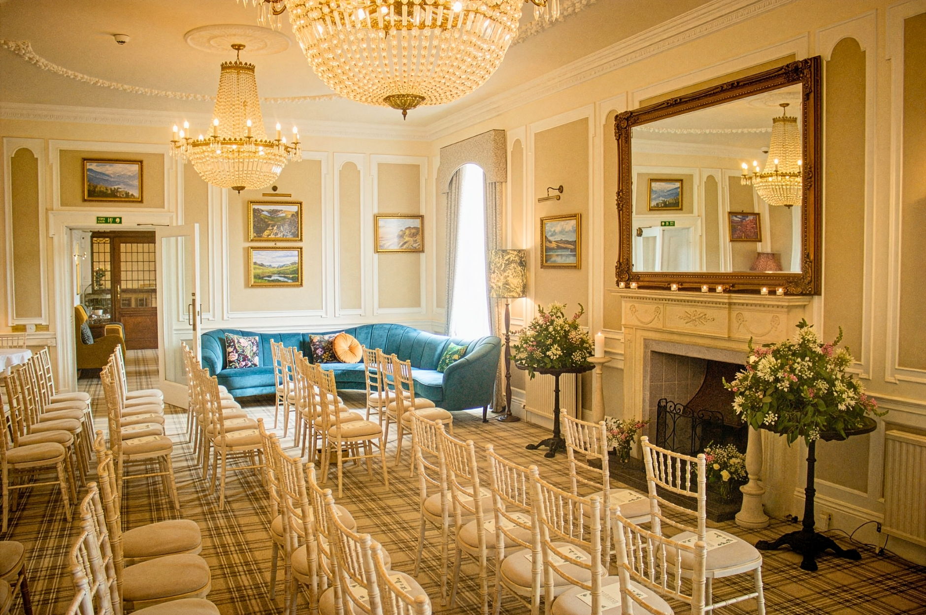 glenesk hotel wedding ceremony set up with chairs and floral decorations, chandeliers