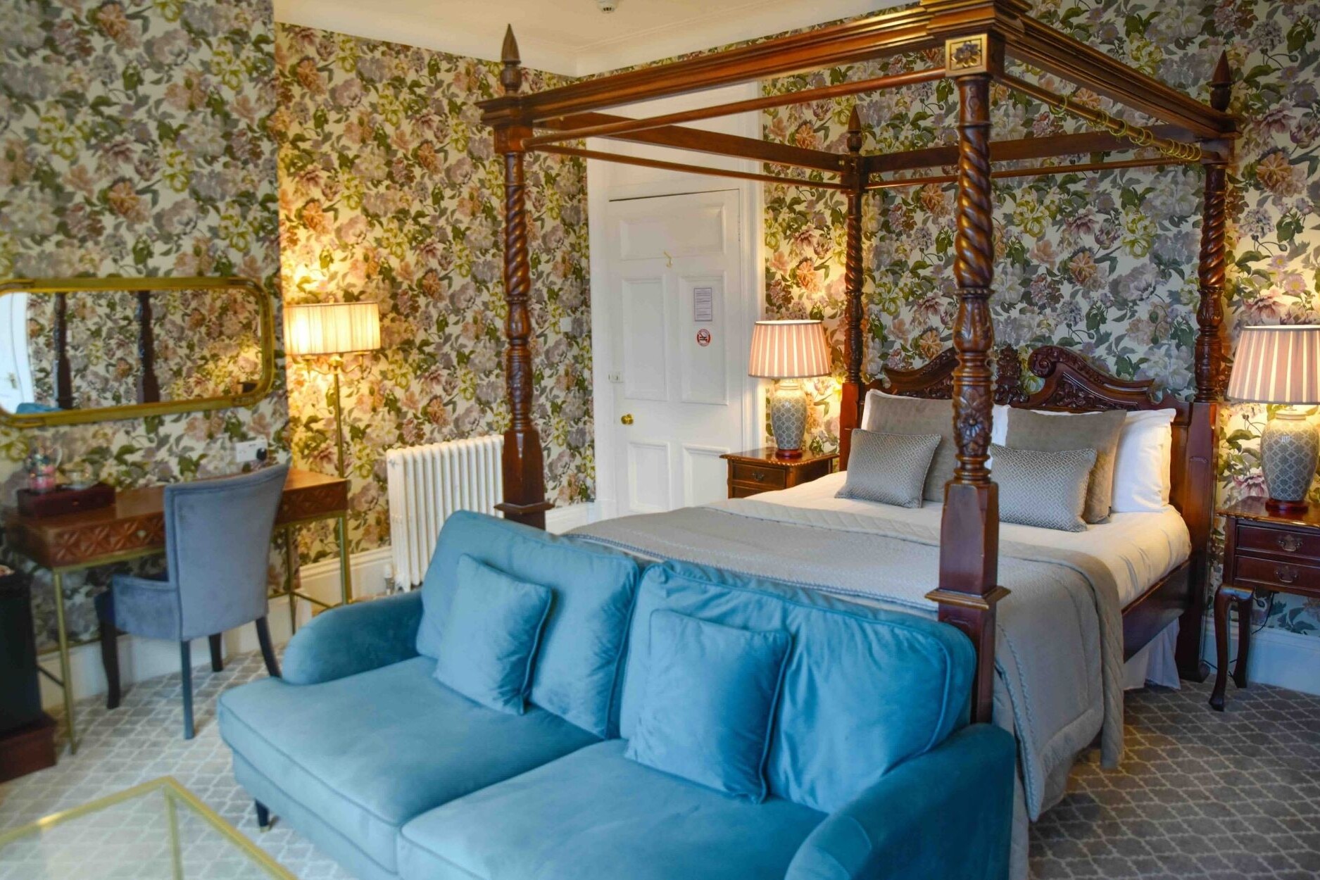 Four poster bed with blue velvet soa and dresing table with mirror in Glenesk Hotel suite